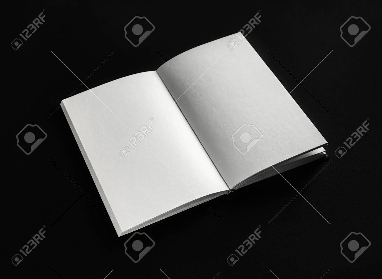 blank open booklet book or notebook on black paper background open booklet