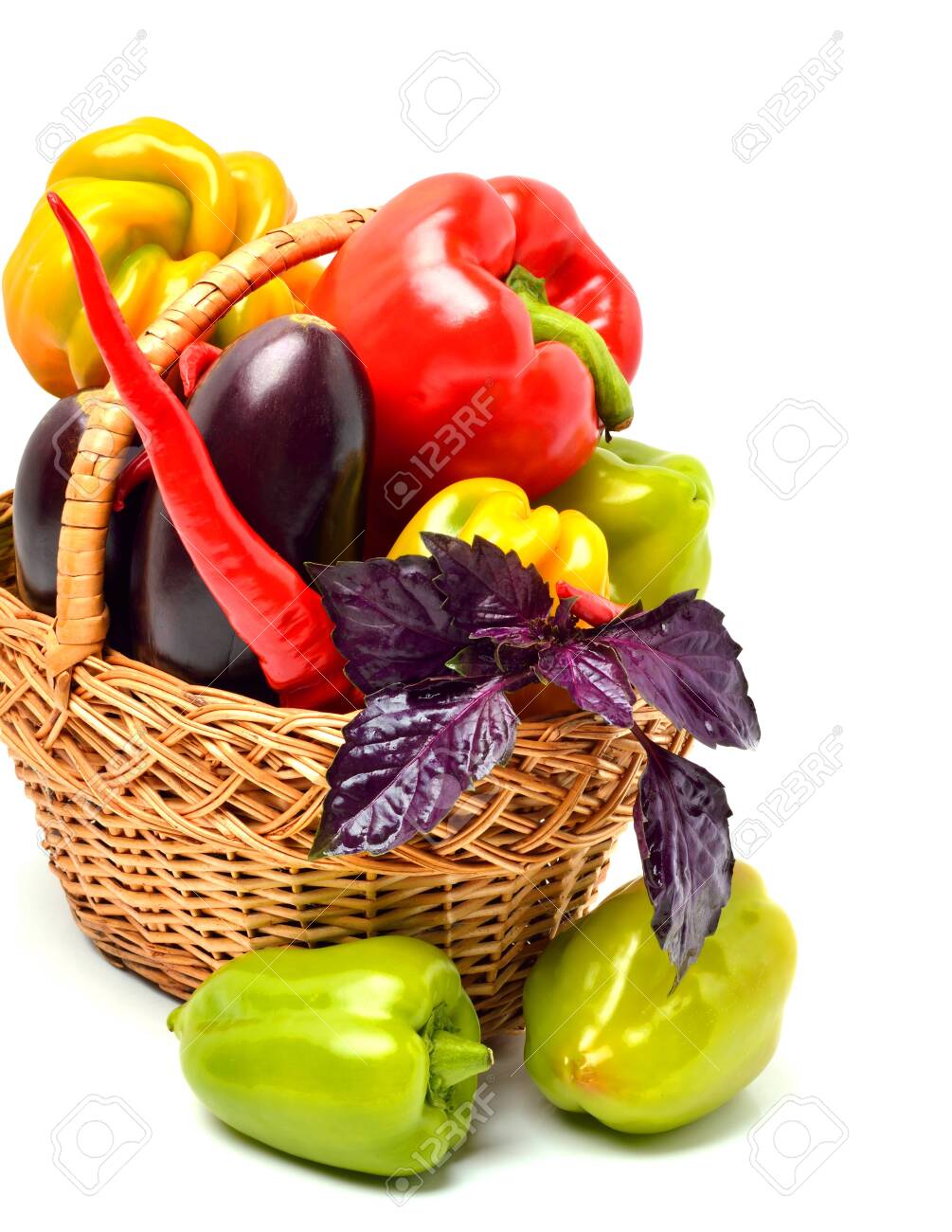 Sweet peppers, eggplant, chilli pepper and basil in the basket isolated on white background - 121736317 Sweet peppers, eggplant, chilli pepper and basil in the basket isolated on white background - 121736317