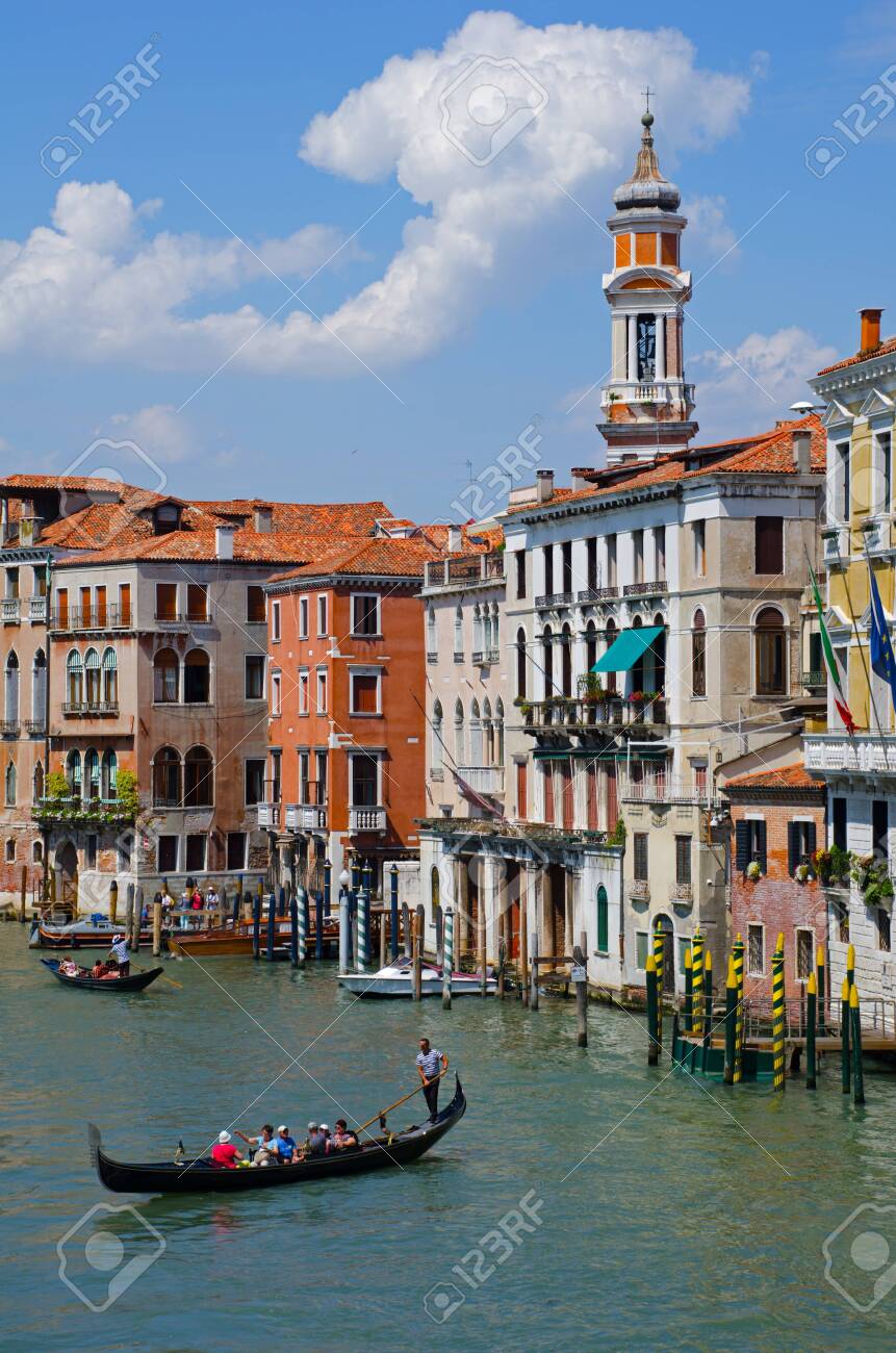 Venetian gondoliers punting gondolas through "canal grande" in Venice, Italy. - 121736322 Venetian gondoliers punting gondolas through "canal grande" in Venice, Italy. - 121736322