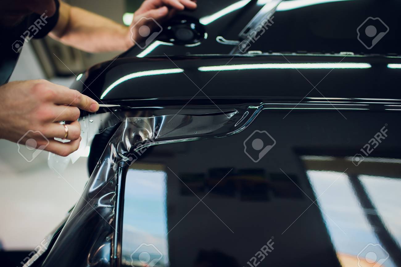 Car Paint Protection >> Worker Hands Installs Car Paint Protection Film Wrap Car Paint Protection >> Worker Hands Installs Car Paint Protection Film Wrap