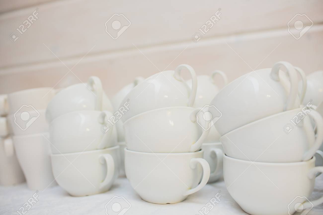 Many Rows Of Pure White Cup And Saucer With Teaspoon Reflection