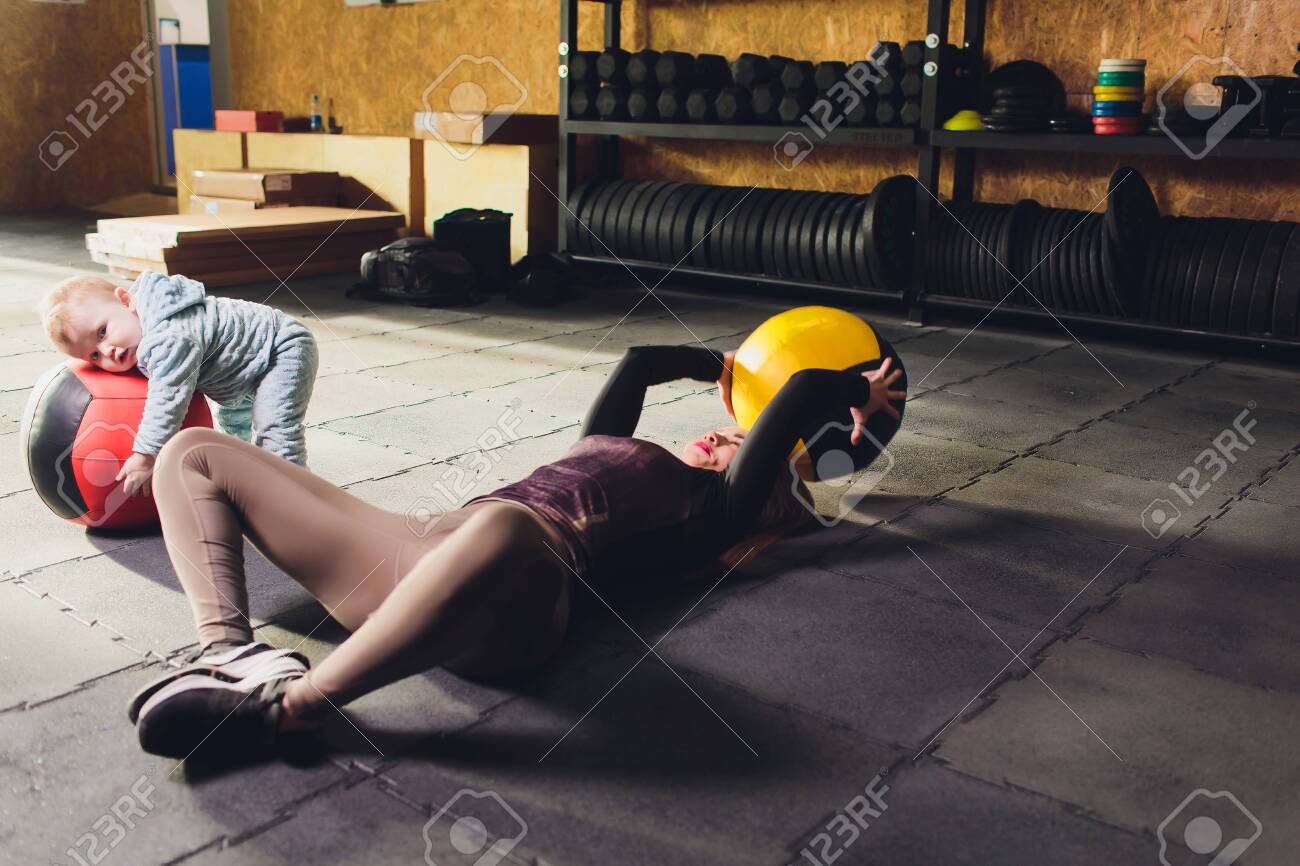 Woman as a therapist at physiotherapy and sports with child in gym. - 120775255 Woman as a therapist at physiotherapy and sports with child in gym. - 120775255