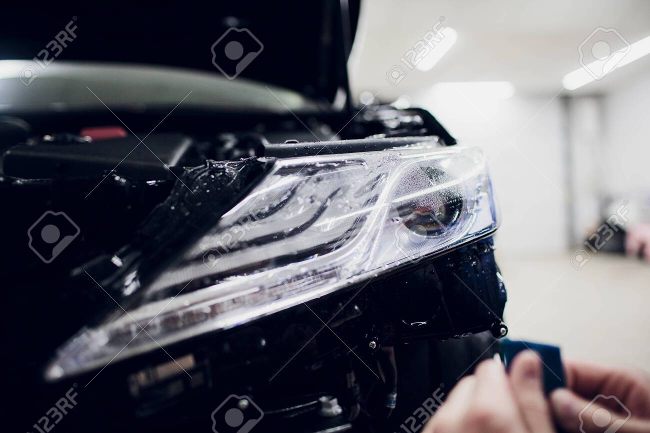 Car Paint Protection >> Worker Hands Installs Car Paint Protection Film Wrap Auto Headlight Car Paint Protection >> Worker Hands Installs Car Paint Protection Film Wrap Auto Headlight