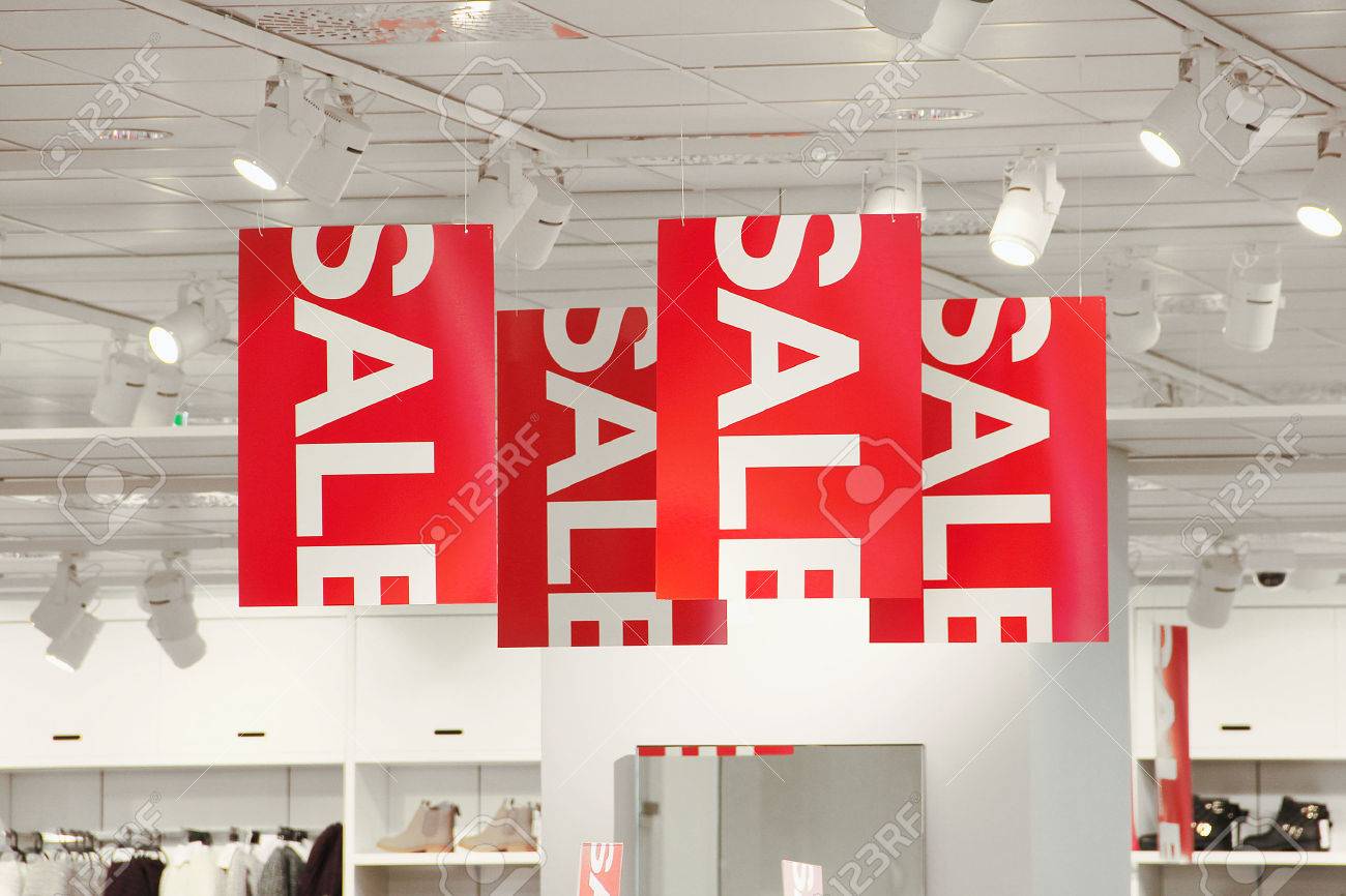 Sale Signs In A Clothing Store Hanging From The Ceiling Stock
