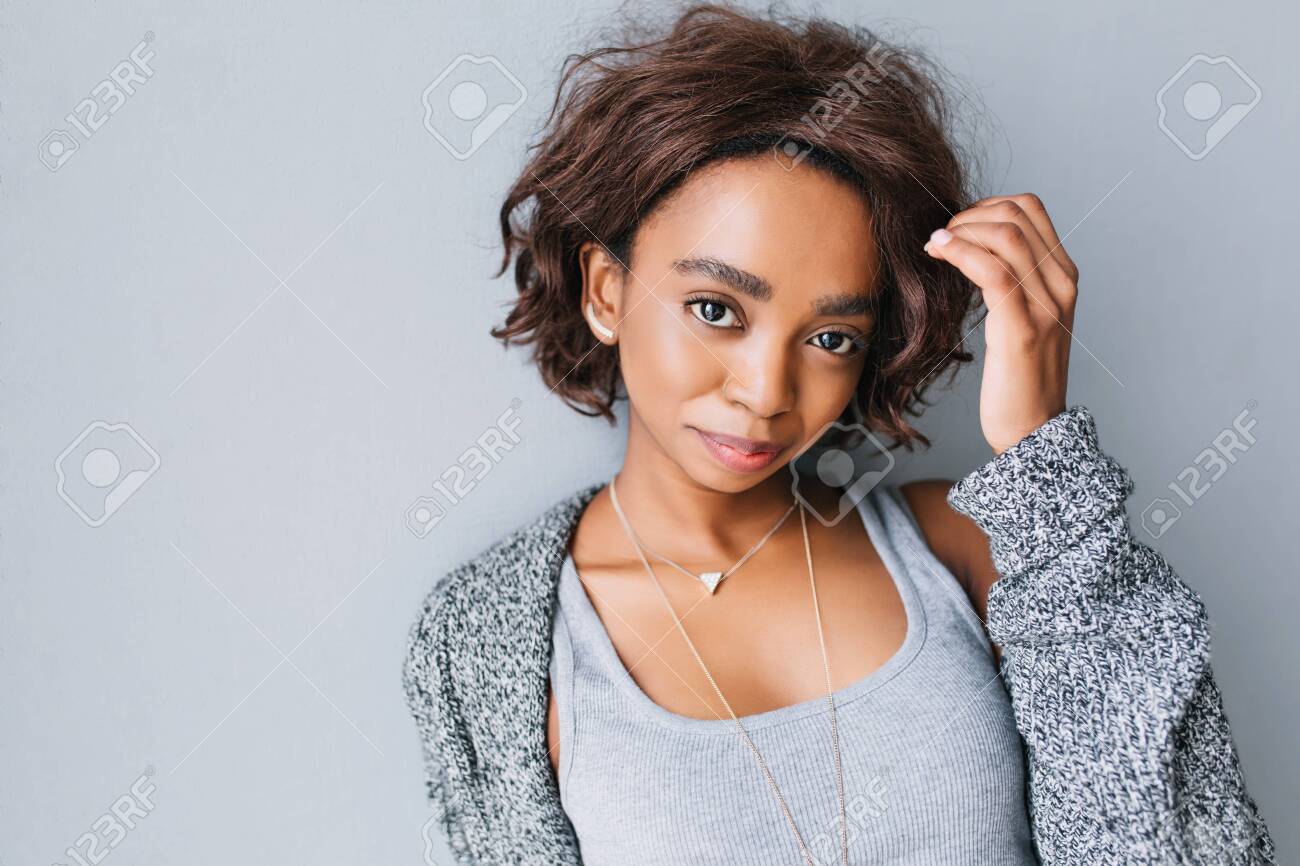 Pretty Young African Girl With Short Curly Hairstyle On Gray