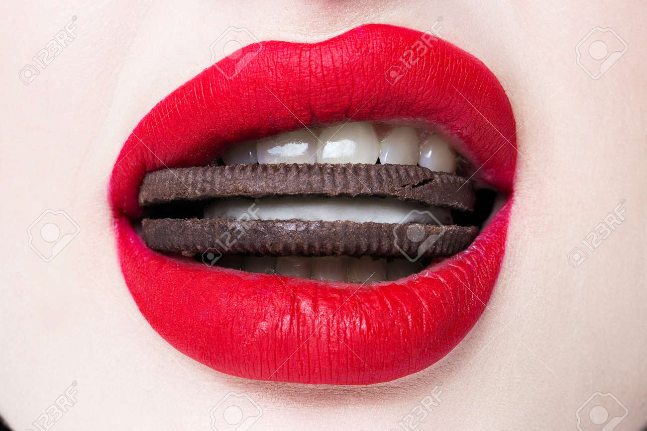 Red lips with biscuits in the mouth closeup - 170929820 Red lips with biscuits in the mouth closeup - 170929820