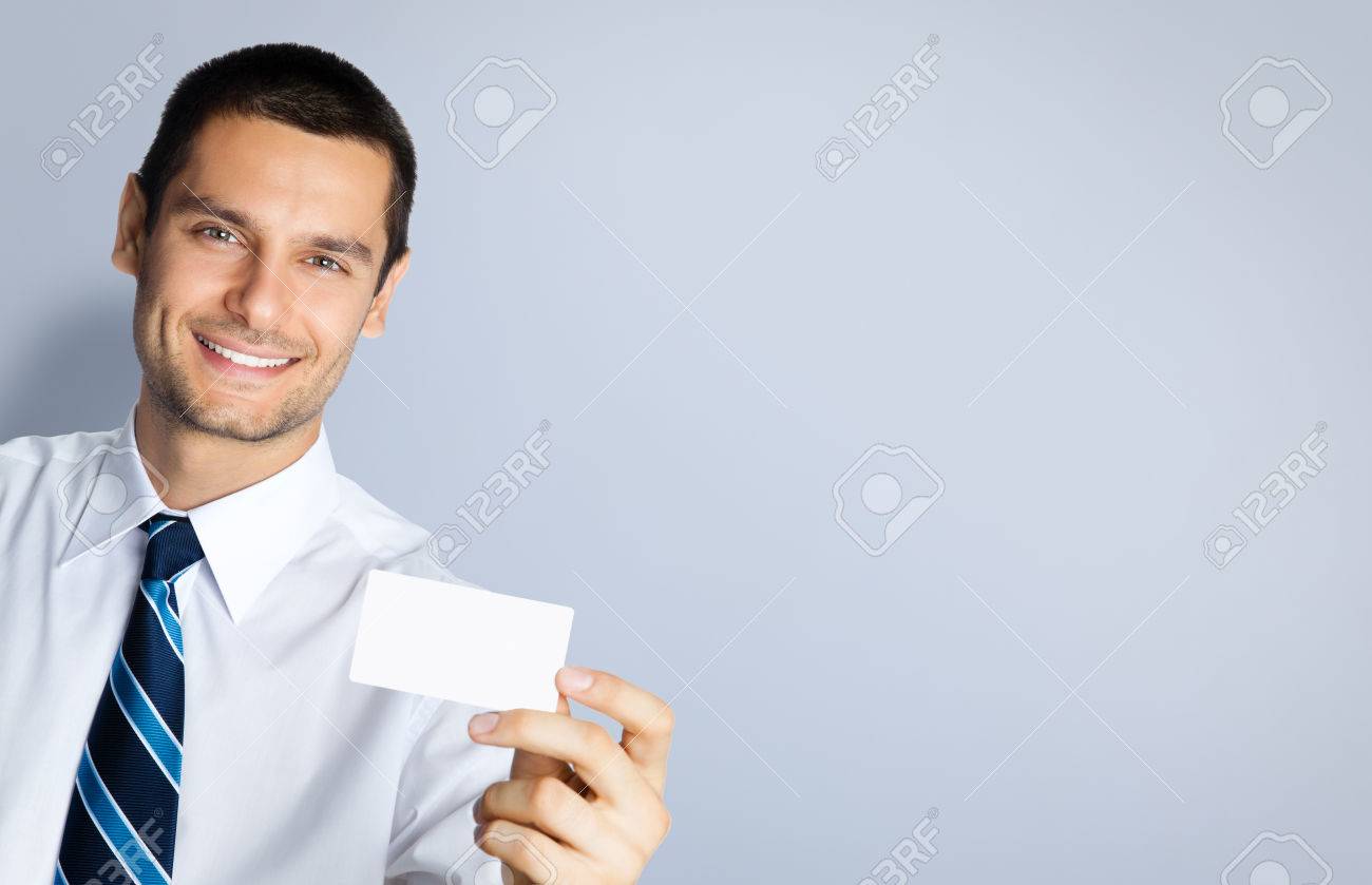 Portrait of smiling businessman showing blank business or plastic credit card, against grey background. Copyspace blank area for slogan or text. Business and success concept. - 41221597 Portrait of smiling businessman showing blank business or plastic credit card, against grey background. Copyspace blank area for slogan or text. Business and success concept. - 41221597