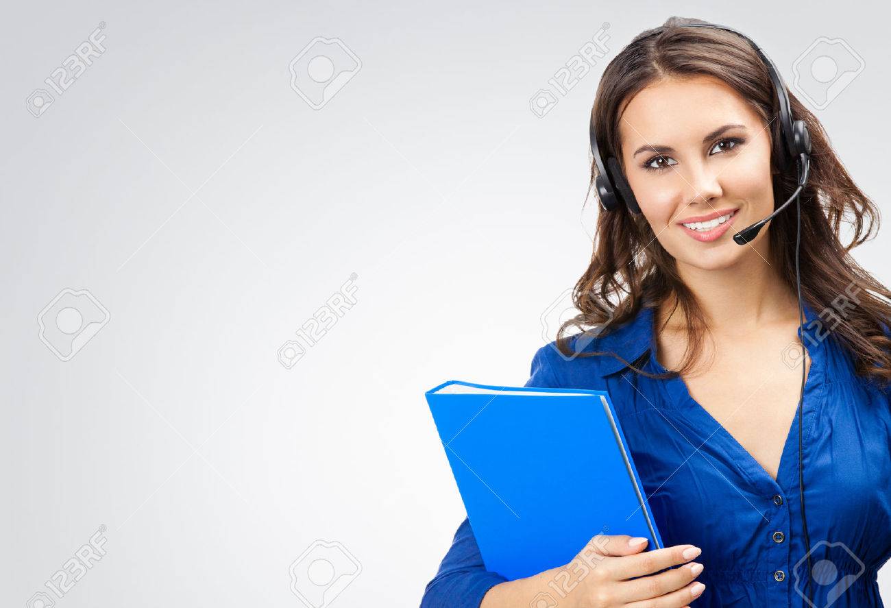 Portrait of happy smiling cheerful beautiful young support phone operator in headset with blue folder, with blank copyspace area for slogan or text, posing at studio against grey background - 41556508 Portrait of happy smiling cheerful beautiful young support phone operator in headset with blue folder, with blank copyspace area for slogan or text, posing at studio against grey background - 41556508