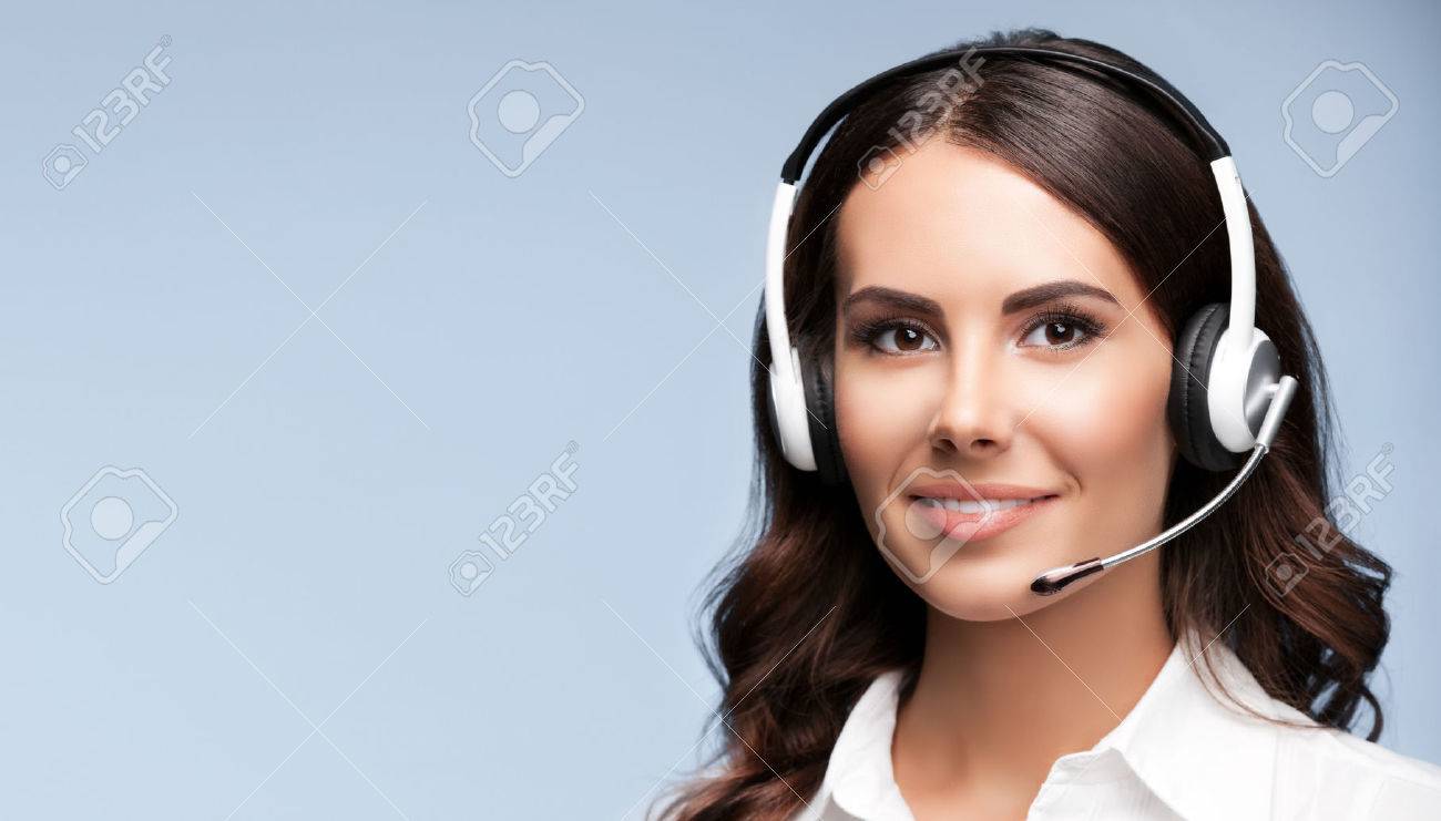 Female customer support phone operator in headset, against grey background, with copyspace area for slogan or text message - 50079033 Female customer support phone operator in headset, against grey background, with copyspace area for slogan or text message - 50079033