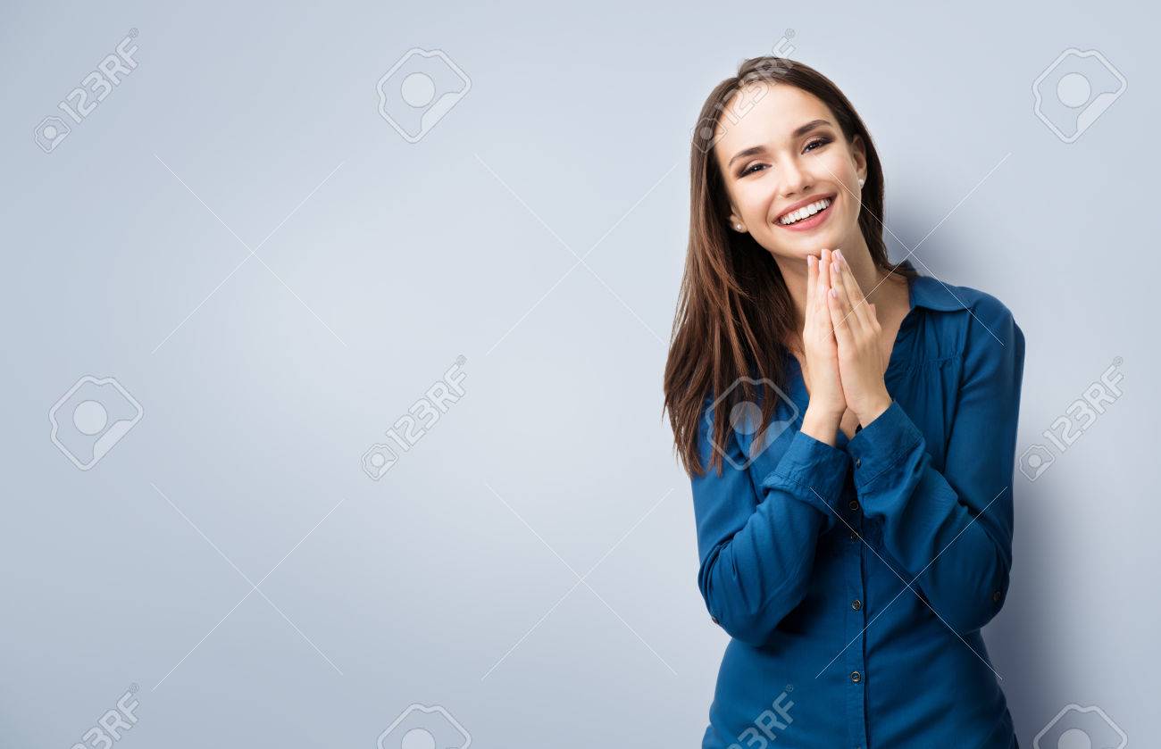 Portrait of happy gesturing smiling young woman in casual smart blue clothing, with copyspace for slogan or text message - 52082929 Portrait of happy gesturing smiling young woman in casual smart blue clothing, with copyspace for slogan or text message - 52082929
