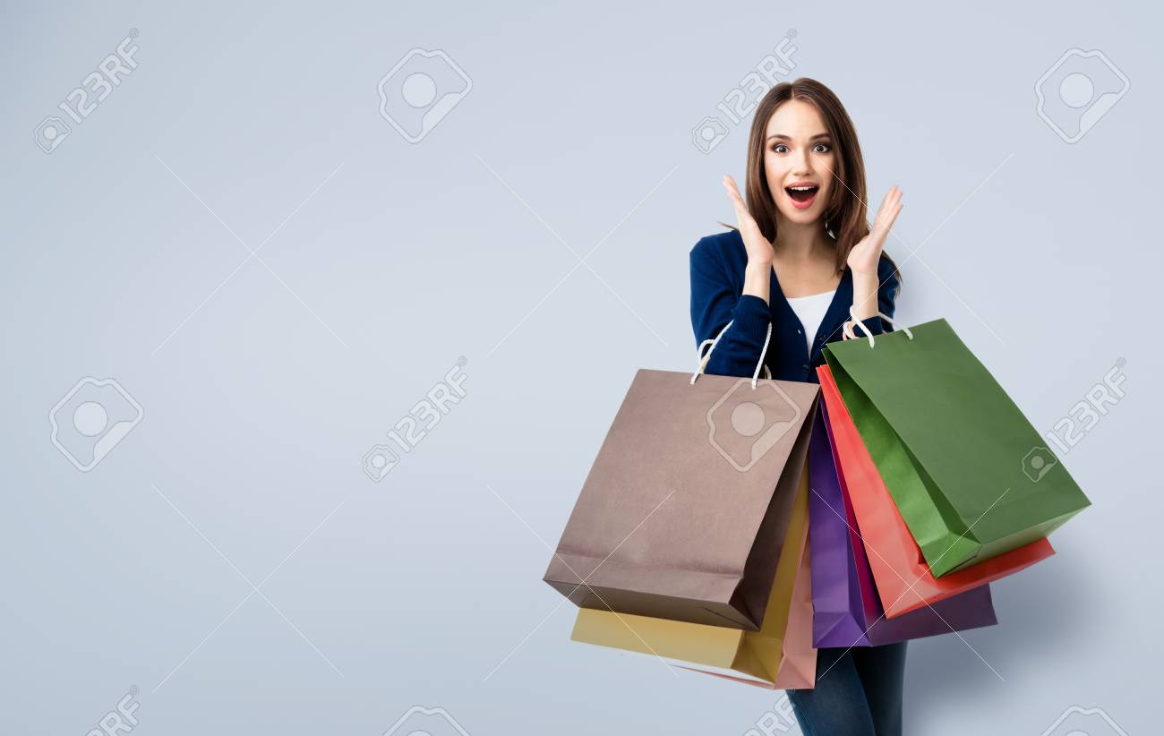Very happy beautiful young woman in casual clothing with shopping bags, with copyspace area for text or slogan - 59131382 Very happy beautiful young woman in casual clothing with shopping bags, with copyspace area for text or slogan - 59131382