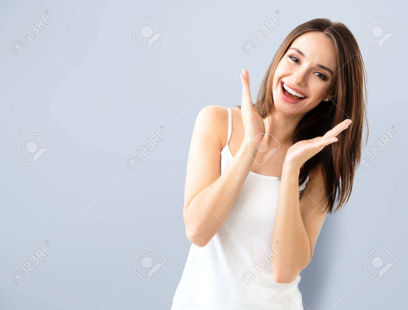 young woman showing smile, in casual smart clothing, with copyspace area for text or slogan - 59131375 young woman showing smile, in casual smart clothing, with copyspace area for text or slogan - 59131375