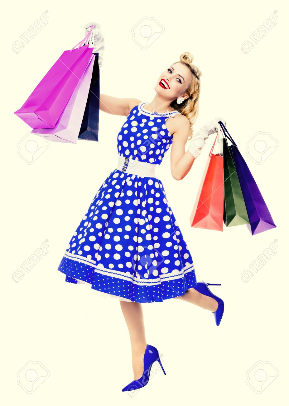 Full body portrait of woman in pin up style blue dress in polka.. Full body portrait of woman in pin up style blue dress in polka..