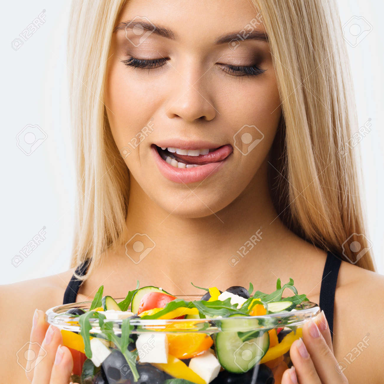 Image of blond woman with tongue lick mouth, looking at glass plate of greece salad. Blonde girl at studio. Keto diet, ketogenic weigh loss, vegetarian concept. Square composition. - 171779200 Image of blond woman with tongue lick mouth, looking at glass plate of greece salad. Blonde girl at studio. Keto diet, ketogenic weigh loss, vegetarian concept. Square composition. - 171779200