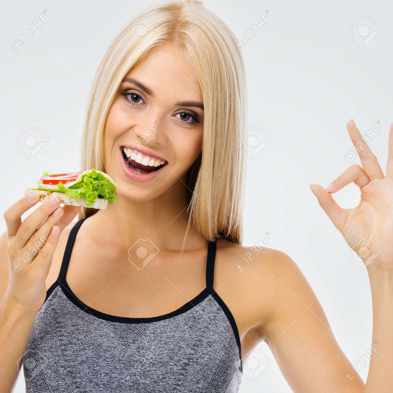 Image of happy excited woman eating vegetarian sandwich, showing ok gesture. Beautiful blond amazed smiling girl in dieting, loss weight and vegetarian concept. - 171729798 Image of happy excited woman eating vegetarian sandwich, showing ok gesture. Beautiful blond amazed smiling girl in dieting, loss weight and vegetarian concept. - 171729798