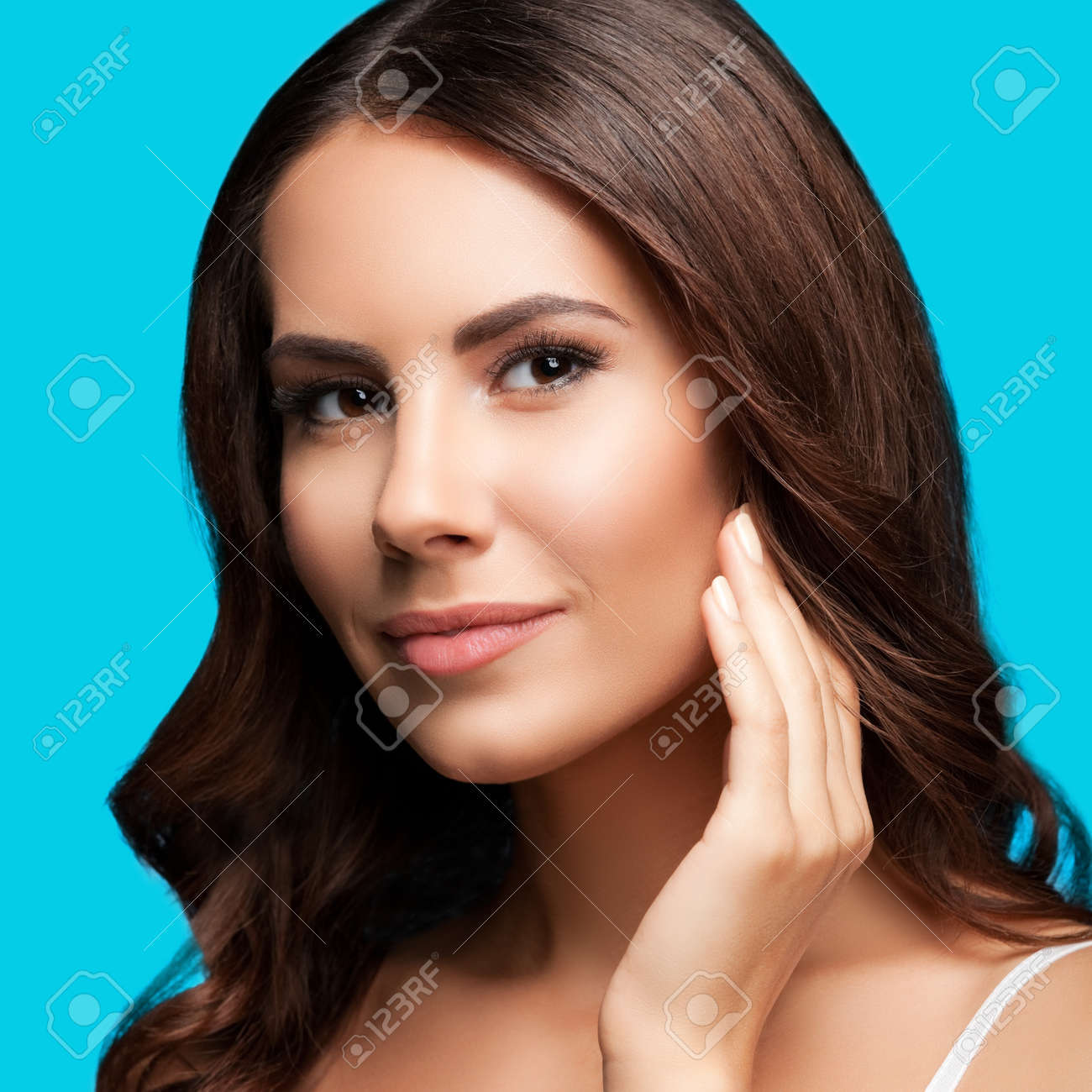 Portrait of beautiful woman in white casual tank top, over aqua blue green background. Brunette girl at studio beauty concept. Square composition image. - 171953008 Portrait of beautiful woman in white casual tank top, over aqua blue green background. Brunette girl at studio beauty concept. Square composition image. - 171953008
