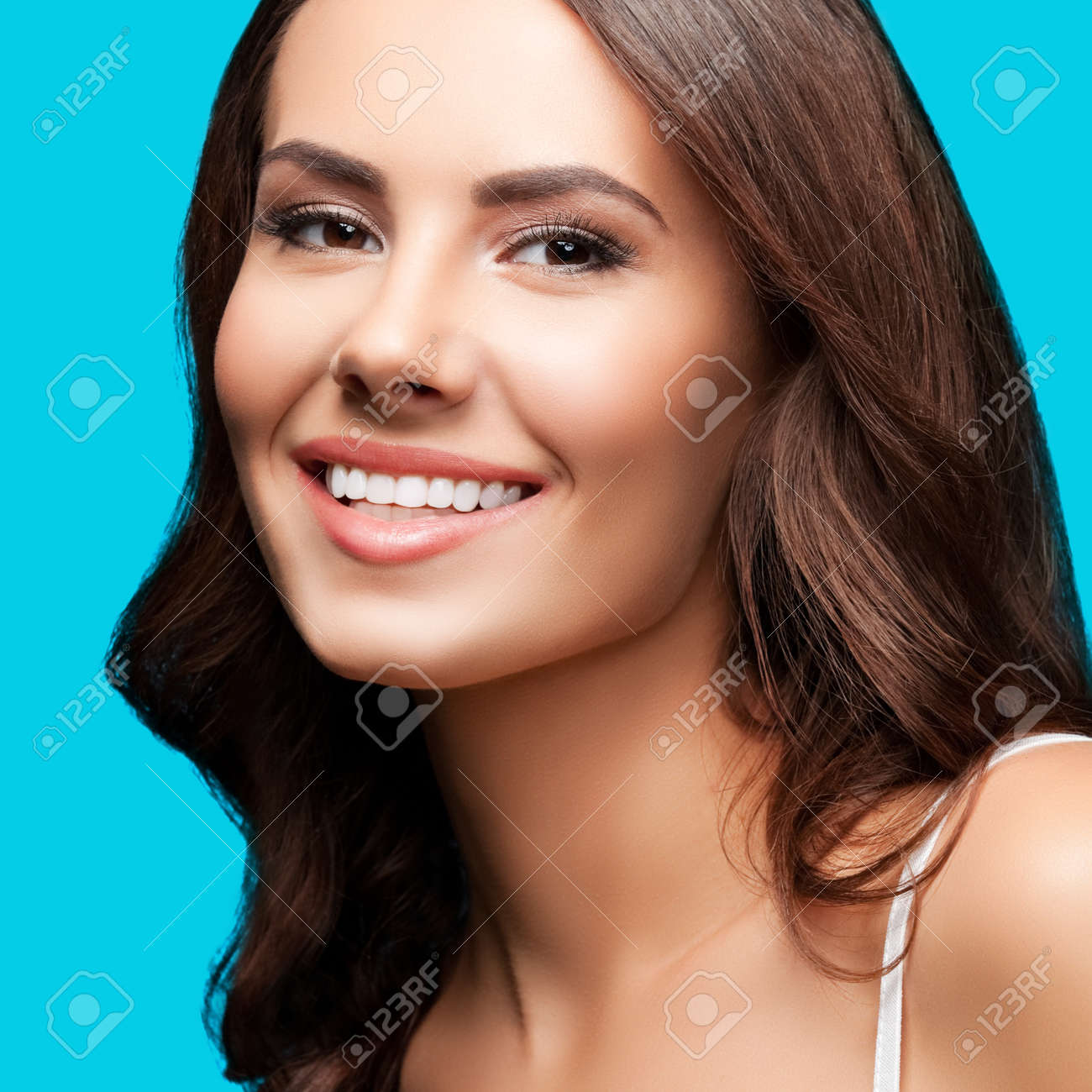 Portrait of smiling beautiful woman in white casual tank top, over aqua blue green background. Brunette girl at studio concept. Square composition. - 171953677 Portrait of smiling beautiful woman in white casual tank top, over aqua blue green background. Brunette girl at studio concept. Square composition. - 171953677