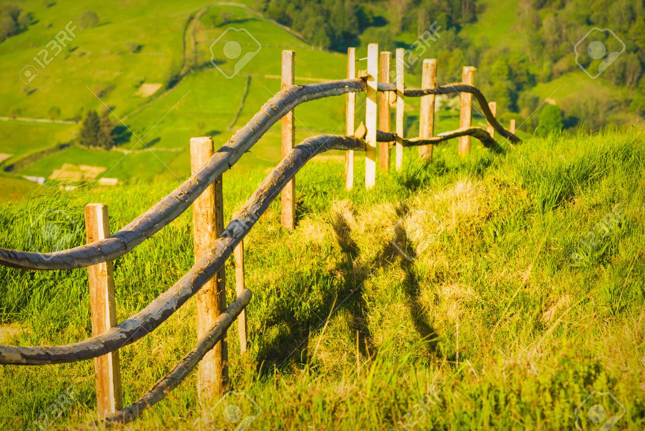 wooden countryside fence in the carpathian mountain valley stock