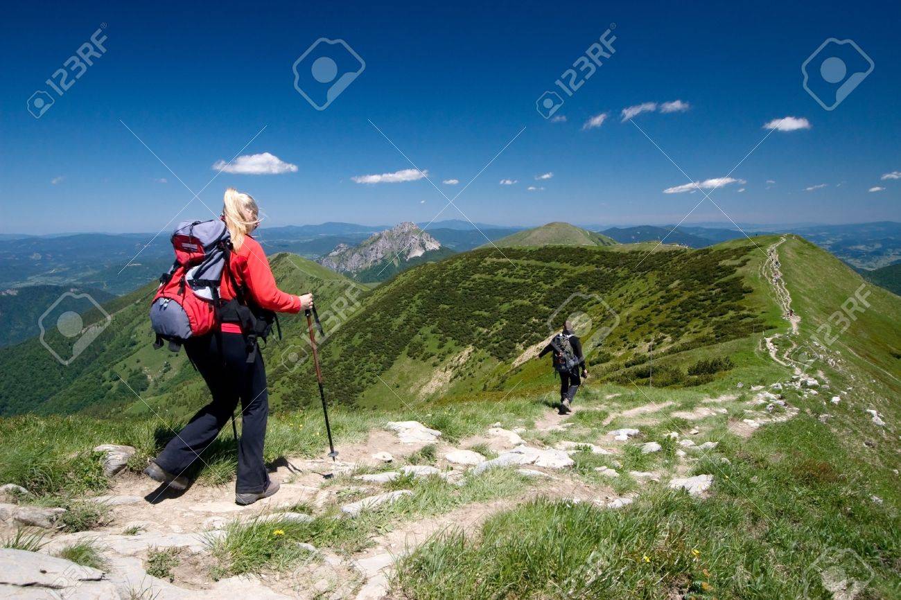 Couple is hiking in mountains, Mala Fatra, Slovakia. Velky Rozsutec in background - 5067261 Couple is hiking in mountains, Mala Fatra, Slovakia. Velky Rozsutec in background - 5067261