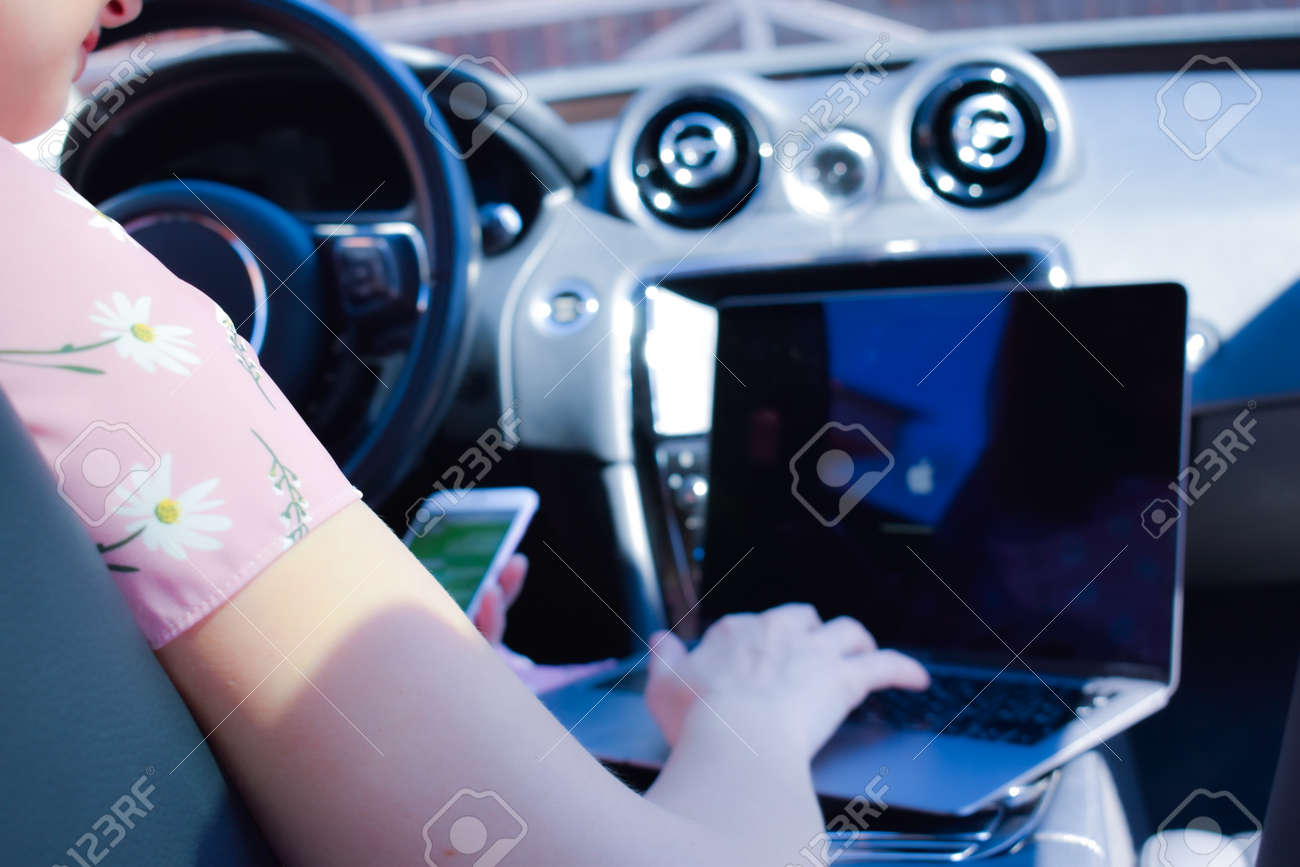 Work in the journey. Professional woman inside an expensive car. Working environment. - 146631269 Work in the journey. Professional woman inside an expensive car. Working environment. - 146631269
