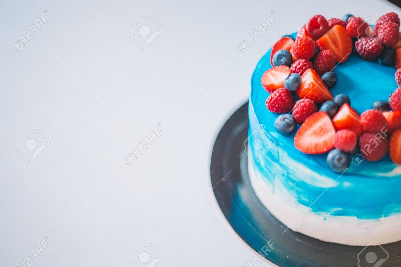 Close Up Festive Blue And White Cake Decorated With Fruits