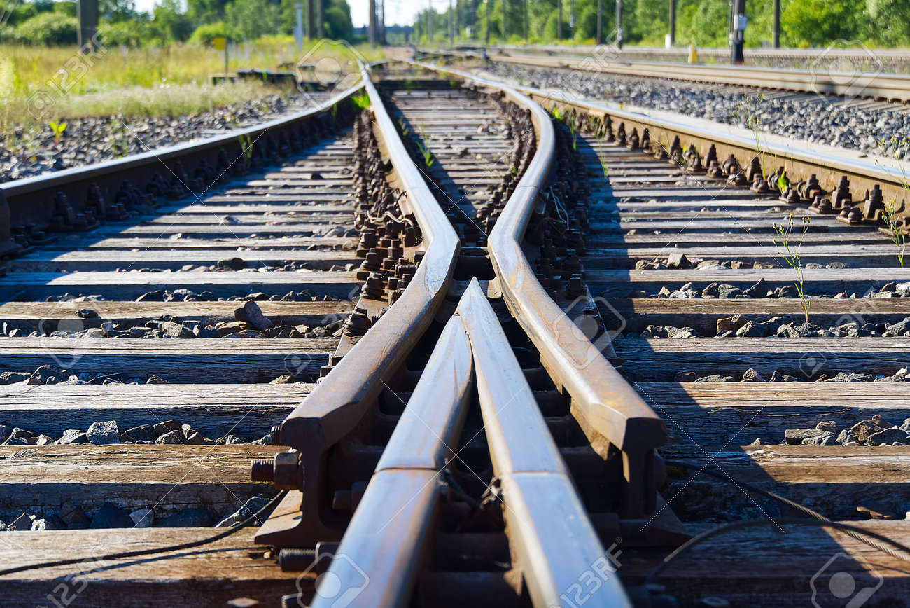 Railroad closeup. Railway tracks, Iron rusty train railway detail over dark stones. - 149920004 Railroad closeup. Railway tracks, Iron rusty train railway detail over dark stones. - 149920004