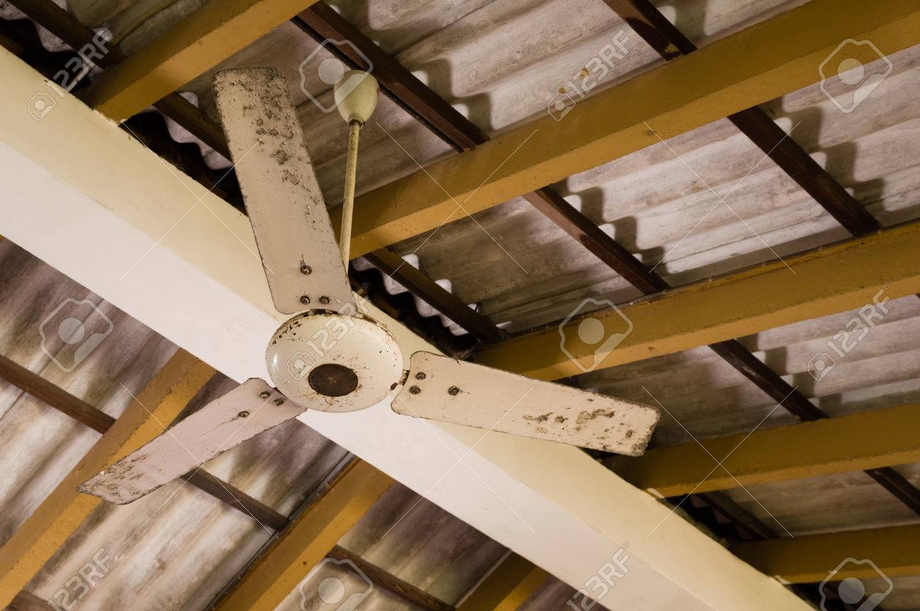 Old Ceiling Fan Hanging Under An Asbestos Roof Stock Photo