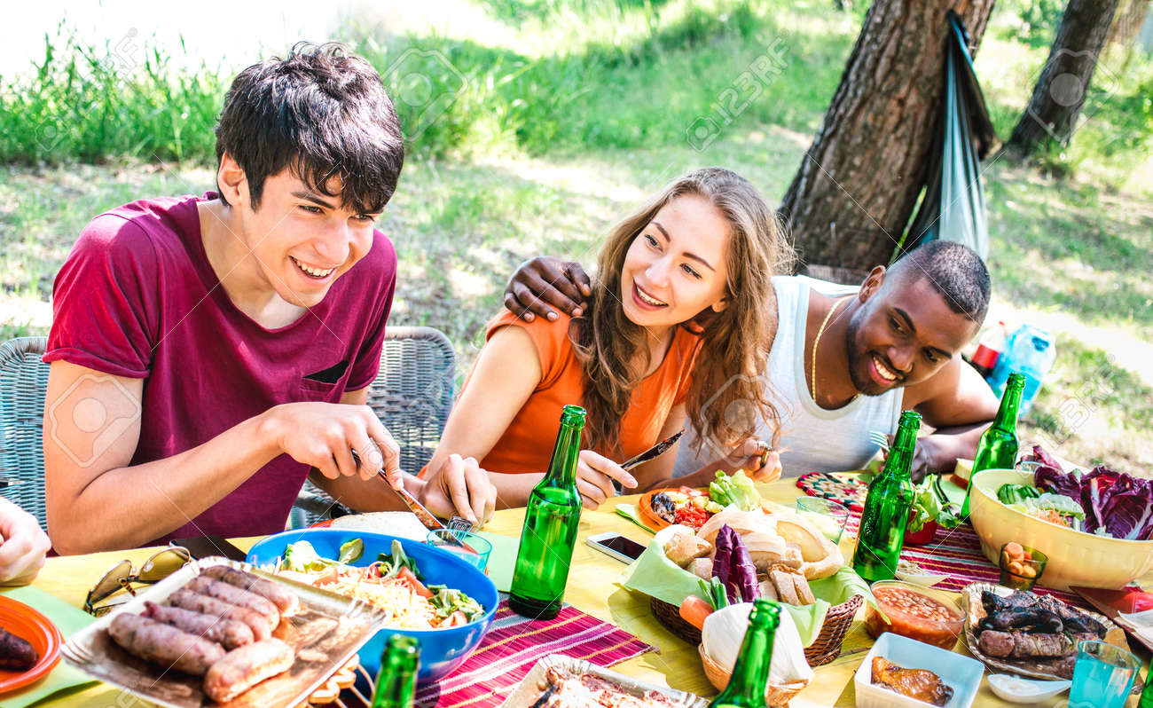 Happy people having fun together at barbecue picnic party - Young multiracial friends at pic nic social gathering - Youth life style concept with guys and girls eating at barbeque - Warm bright filter - 166975454 Happy people having fun together at barbecue picnic party - Young multiracial friends at pic nic social gathering - Youth life style concept with guys and girls eating at barbeque - Warm bright filter - 166975454
