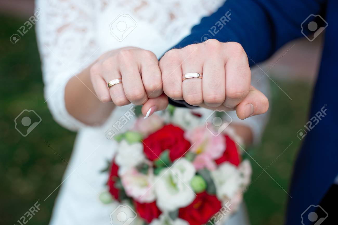 Close-up Bride and grooms hands with wedding rings - 100151661 Close-up Bride and grooms hands with wedding rings - 100151661