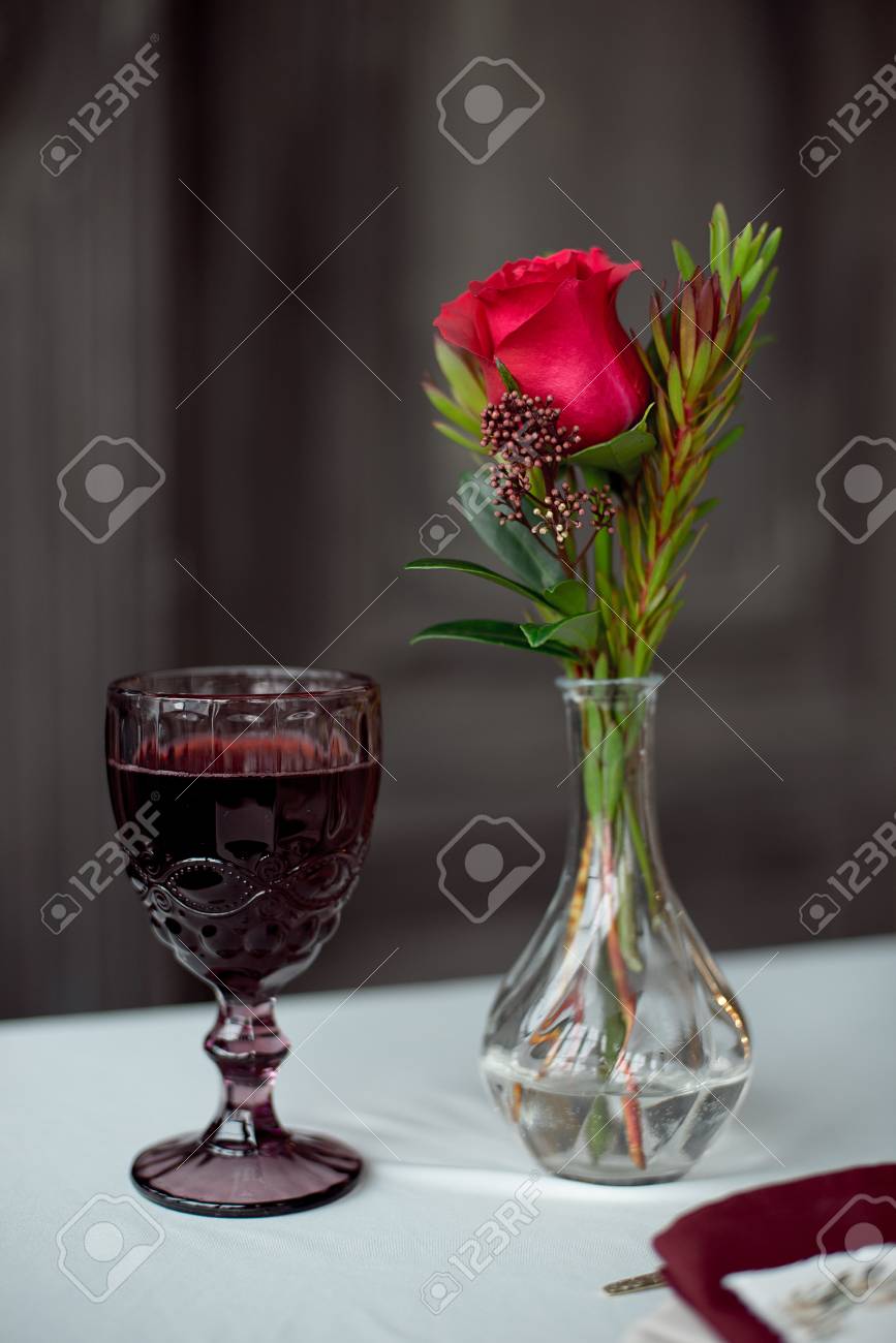 Event Table With Flower Vases And Wine Glasses Stock Photo