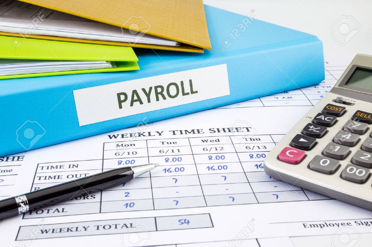 payroll word on blue binder place on weekly time sheet and payroll