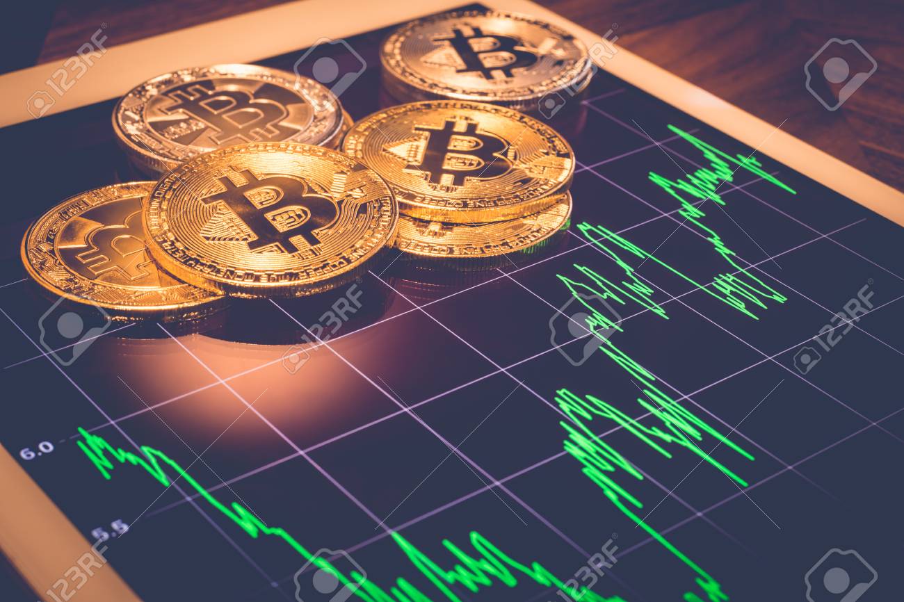 Cryptocurrency, Focus Bitcoin On Tablet Screen That Showing Green Price Or  Stock Market Performance Graph, Light Reflect With Vintage Filter.  Decentralized, Exchange Digital Money Through Blockchain. Stock Photo,  Picture and Royalty Free