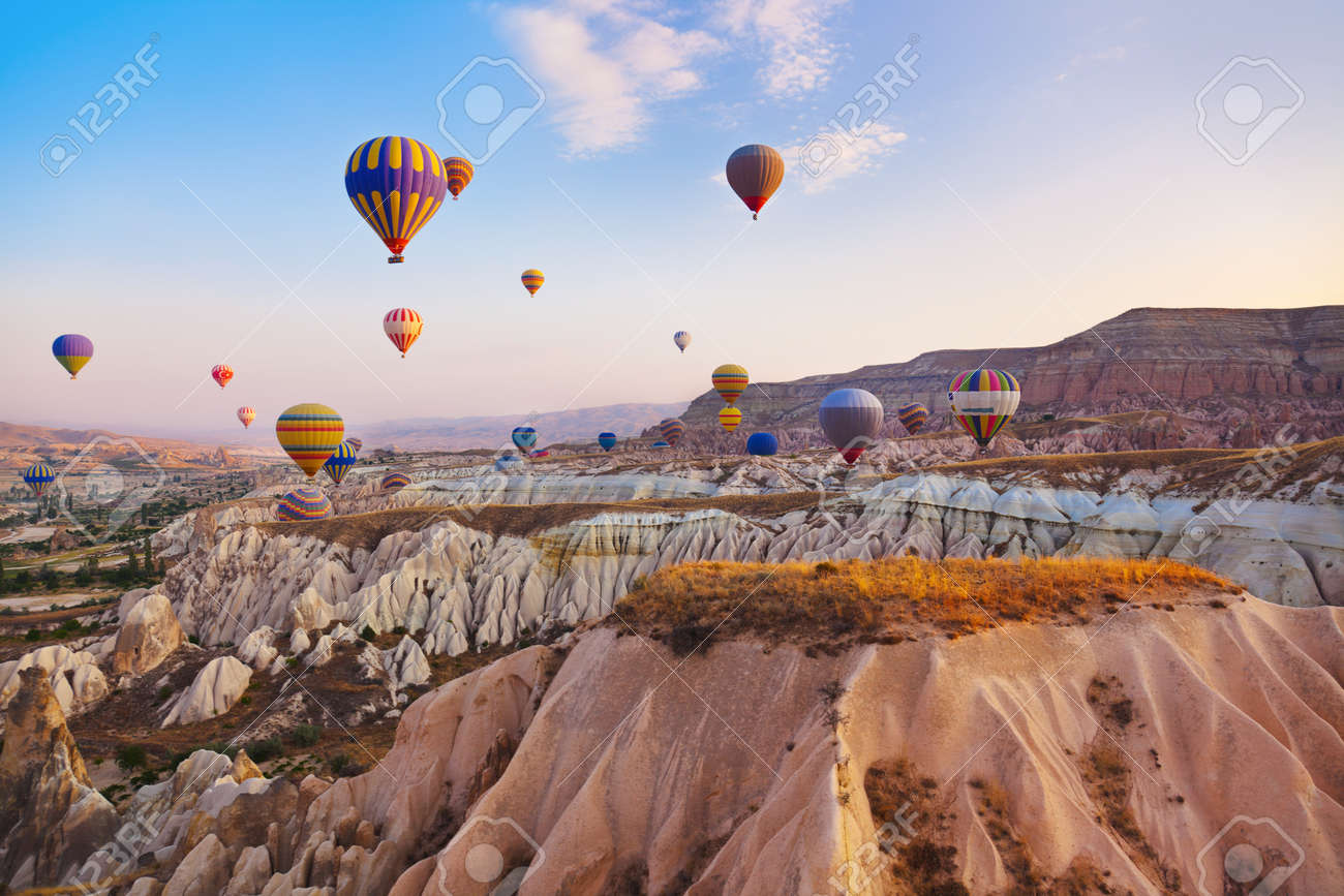 Hot air balloon flying over rock landscape at Cappadocia Turkey - 40592256 Hot air balloon flying over rock landscape at Cappadocia Turkey - 40592256