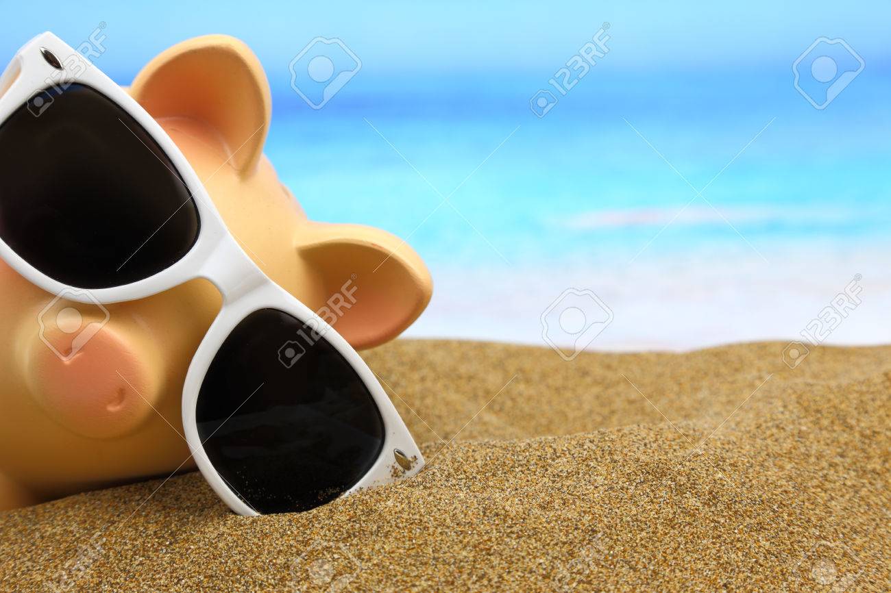 Summer piggy bank with sunglasses on the beach - 26815434 Summer piggy bank with sunglasses on the beach - 26815434