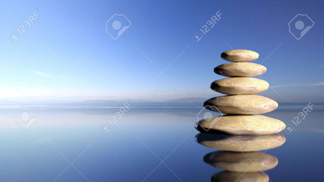 Zen stones stack from large to small in water with blue sky and peaceful landscape background. - 50022783 Zen stones stack from large to small in water with blue sky and peaceful landscape background. - 50022783