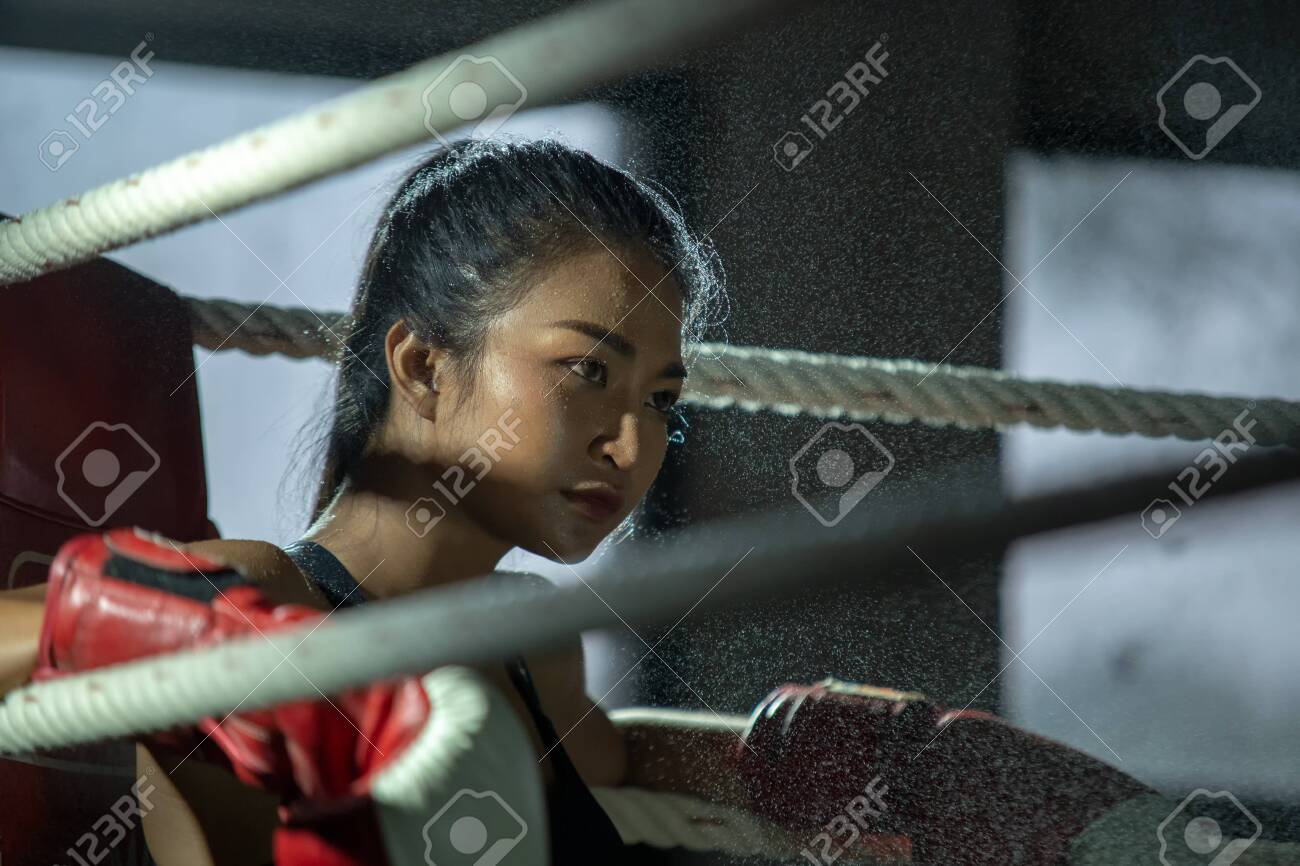 Upset Young Fighter Boxer Girl Wearing Boxing Gloves In Gyma Female Boxer Taking A Break From Her Practice. Image 122774738