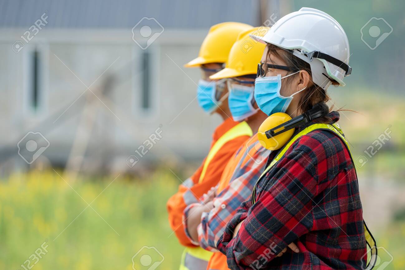 Group of Asian engineers wearing protective mask to Protect Against Covid-19 with helmet safety in the construction site,Coronavirus has turned into a global emergency,Safety concept. - 148583684 Group of Asian engineers wearing protective mask to Protect Against Covid-19 with helmet safety in the construction site,Coronavirus has turned into a global emergency,Safety concept. - 148583684