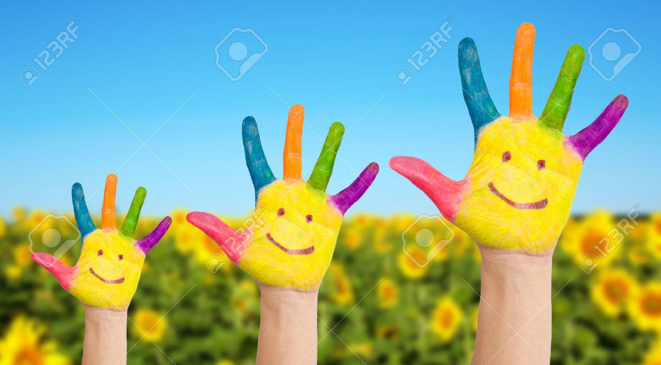 three colorful painted hands with smiling face of family mother