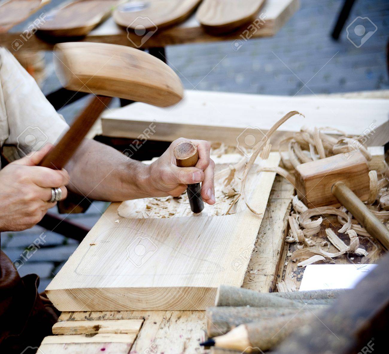 The joiner does a dimple in a board, working with a chisel - 14993523 The joiner does a dimple in a board, working with a chisel - 14993523