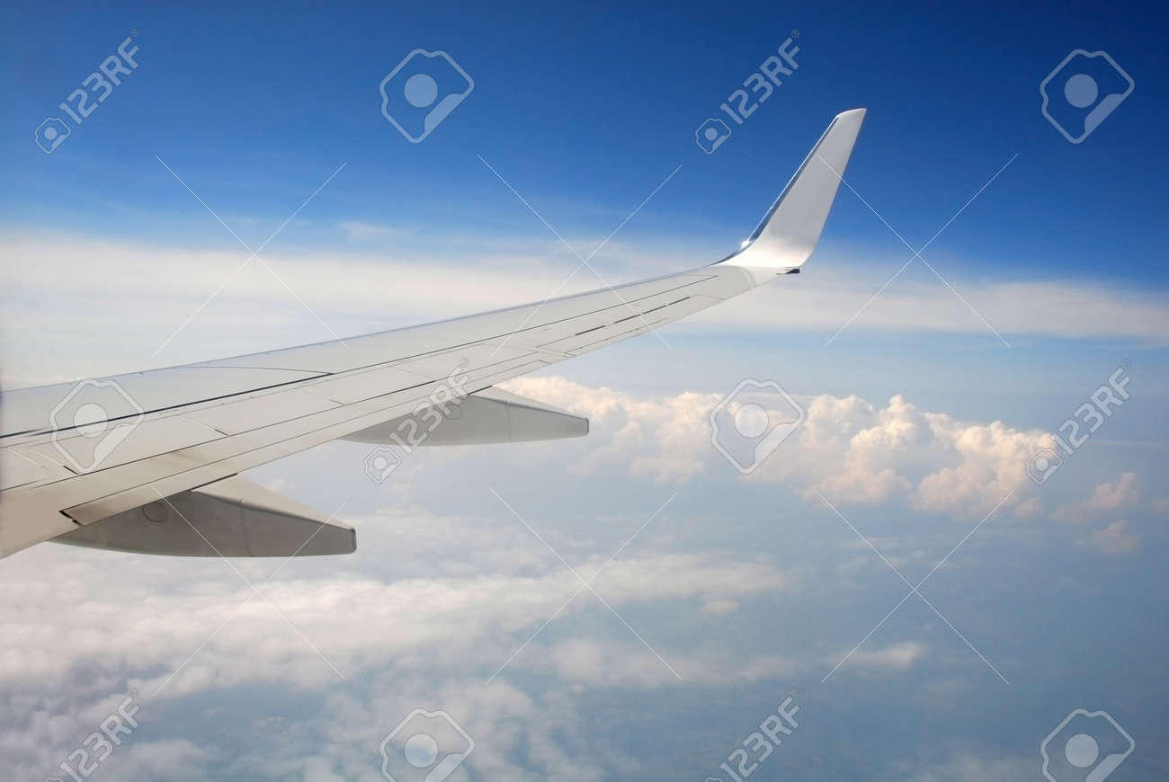 View of the clouds from the cockpit. Cumulus clouds under the wing of a high-flying passenger plane. - 164294444 View of the clouds from the cockpit. Cumulus clouds under the wing of a high-flying passenger plane. - 164294444
