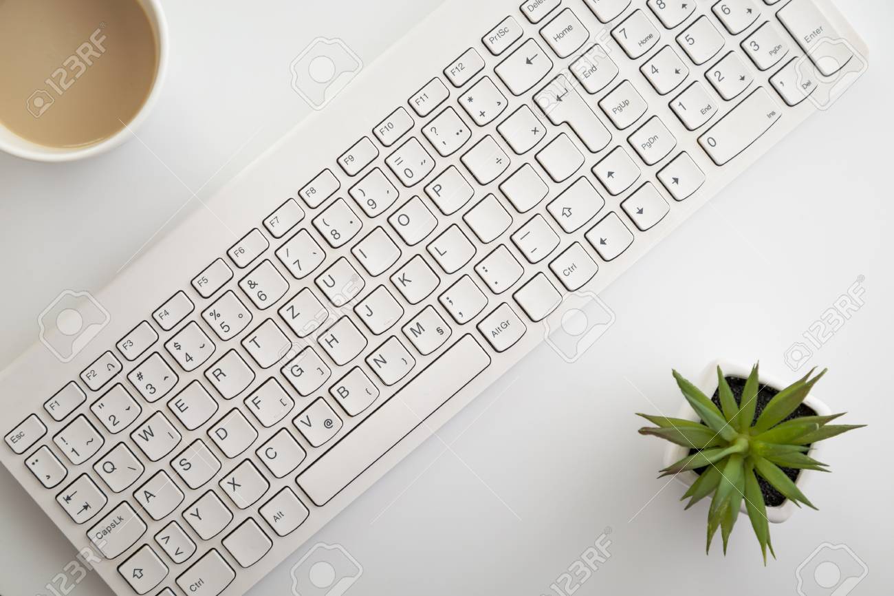Table Top Shot Of A Computer Keyboard, Cup Of Coffee And Flowerpot; Home  Office Working Atmosphere Stock Photo, Picture and Royalty Free Image.  Image 105165971.