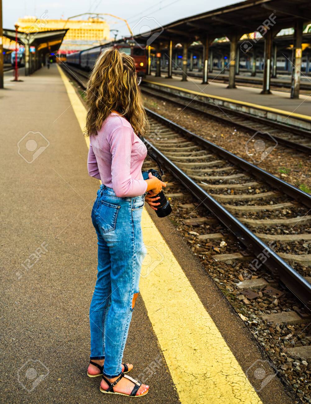 129990735-young-girl-walking-alone-on-tr