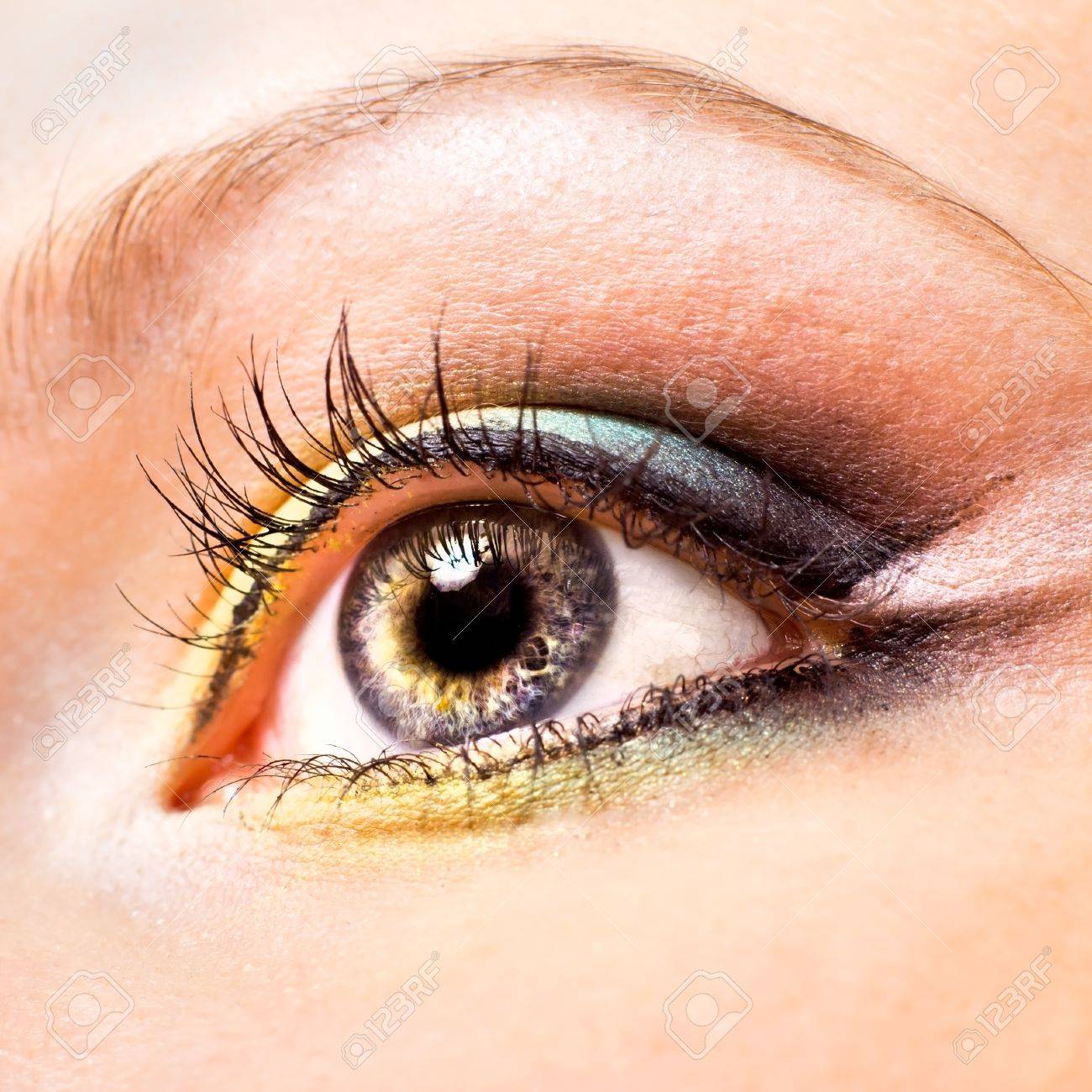 Close-up of beautiful womanish eye with yellow and green make-up - 10285141 Close-up of beautiful womanish eye with yellow and green make-up - 10285141