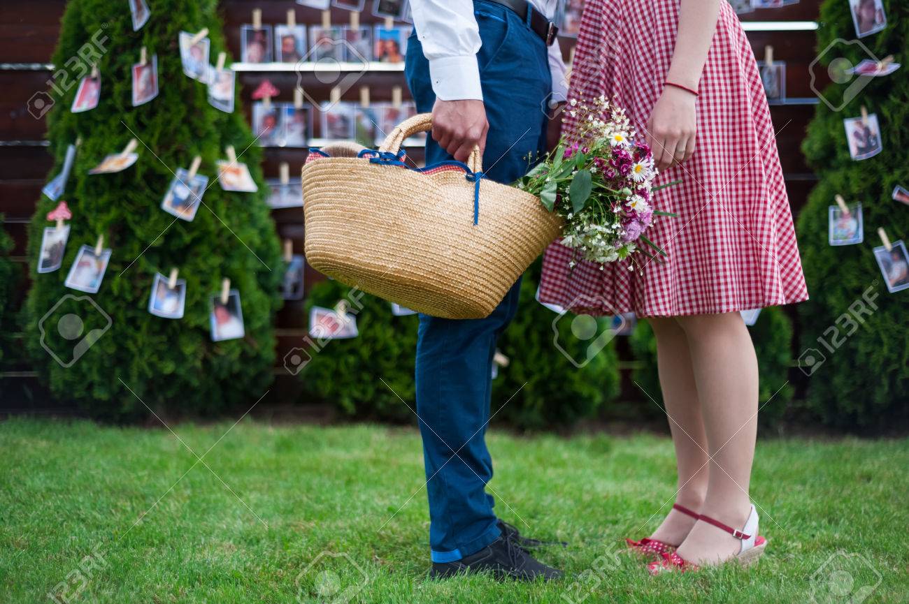 脚しか婚約写真 結婚式 ピクニック 晴れた日 ロマンチックな写真 ドレス ヴィンテージ色をピンで女の子の顔なしの前に 草の中のカップル の写真素材 画像 素材 Image