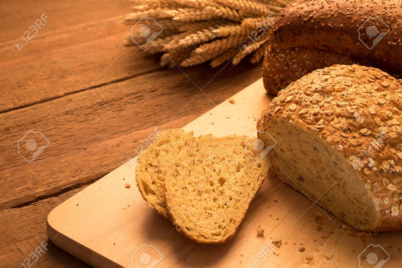 bread on chopping board and rustic tabletop background stock photo