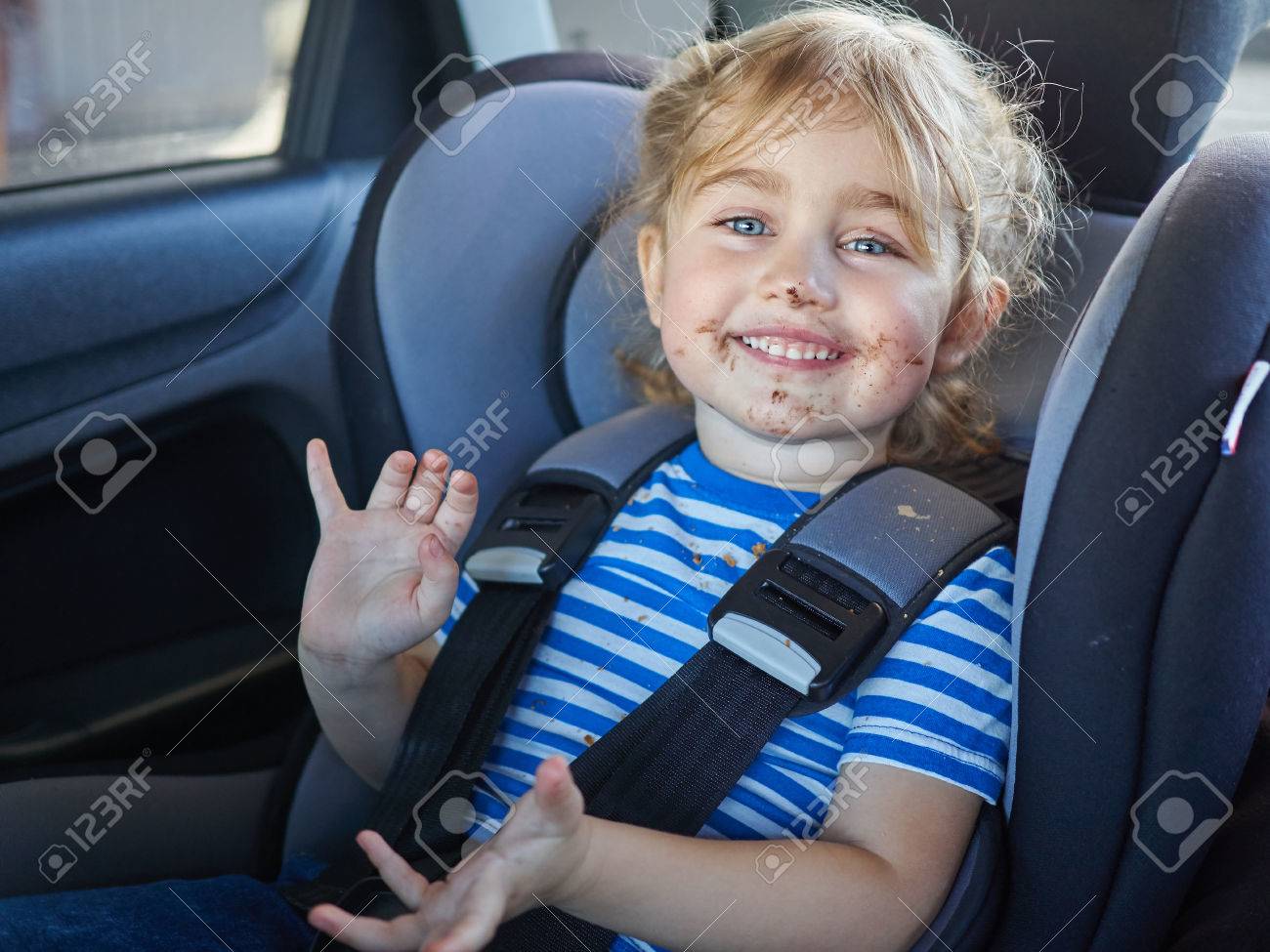 Little dirty girl , baby in a safety car seat. Safety and security - 53131185 Little dirty girl , baby in a safety car seat. Safety and security - 53131185