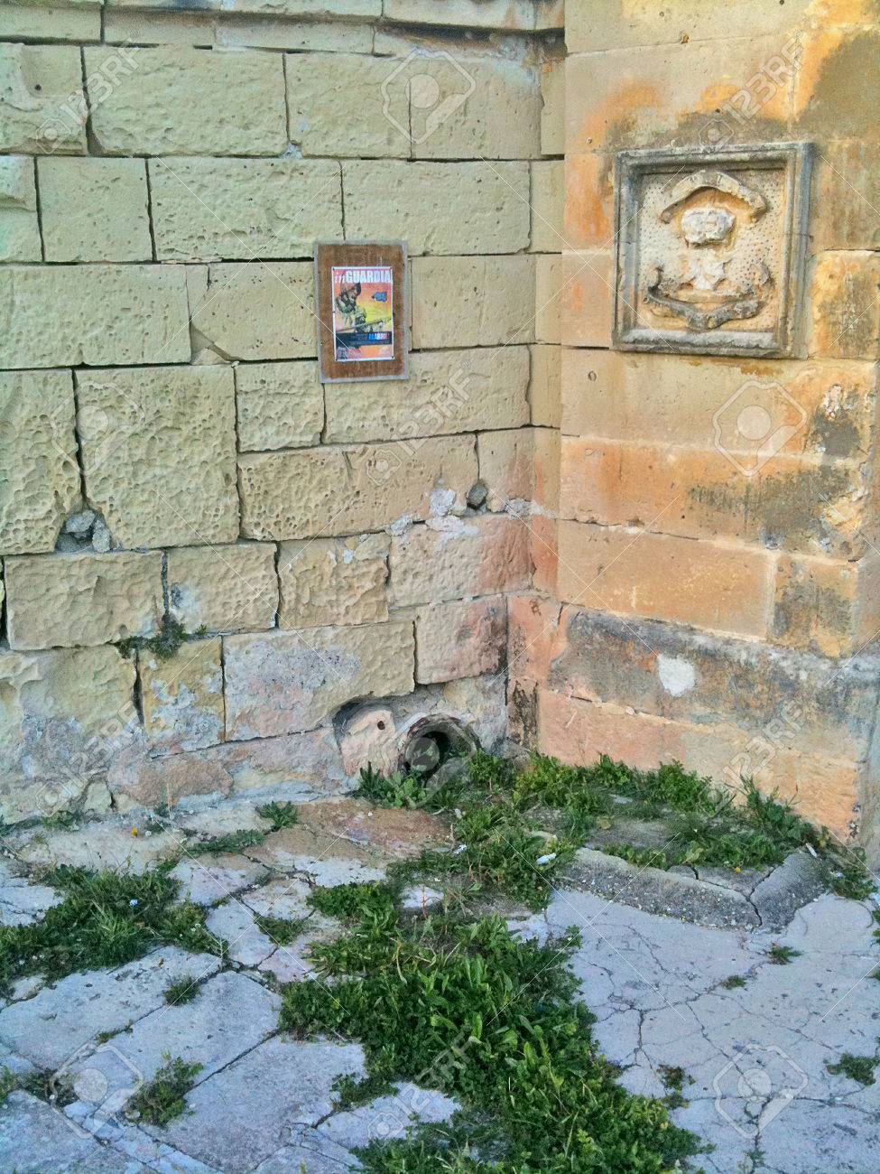 Maltese stonework, artwork, and frame on outside walls - 34392175 Maltese stonework, artwork, and frame on outside walls - 34392175