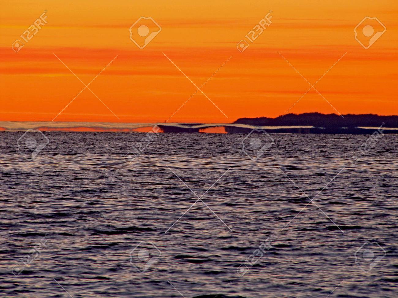 A reflective mirage of an island in the distance over Lake Michigan - 34435177 A reflective mirage of an island in the distance over Lake Michigan - 34435177