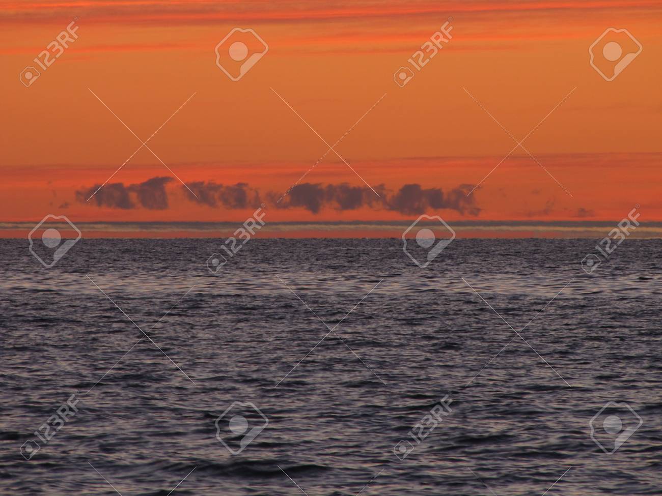 A trail of clouds over Lake Michigan during sunset - 34435178 A trail of clouds over Lake Michigan during sunset - 34435178