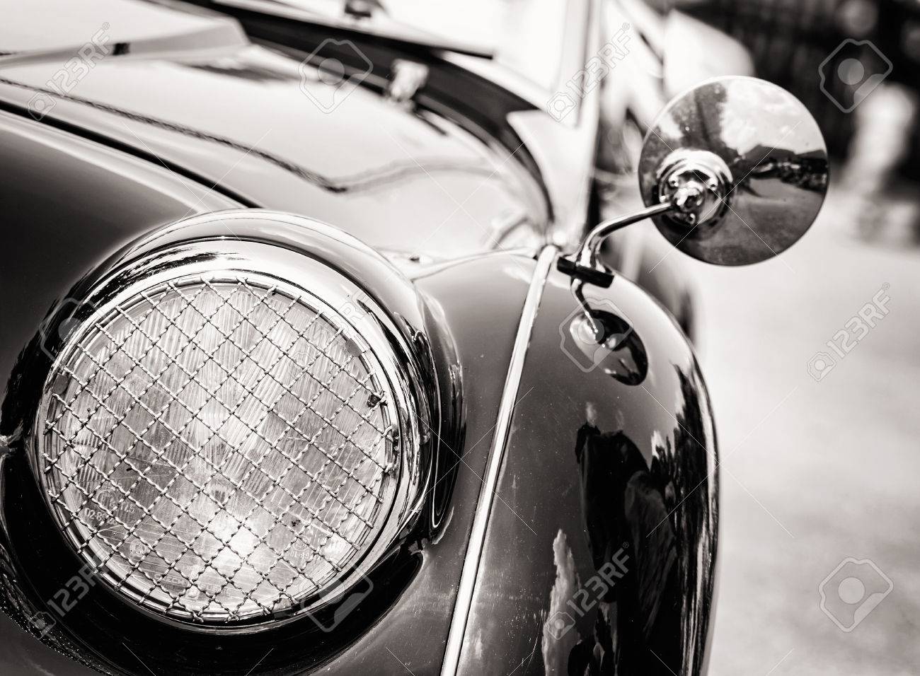 Shiny vintage car. Detail view of the headlight. Retro car. Black and white photo. Front light. Retro automobile scene. Circle headlamp. - 58033845 Shiny vintage car. Detail view of the headlight. Retro car. Black and white photo. Front light. Retro automobile scene. Circle headlamp. - 58033845